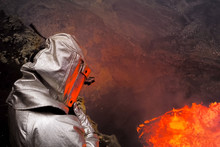 Man Wearing Fire Protection Suit While Standing Against Lava