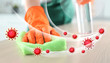 Cleaning vs viruses. Woman washing table with sponge and disinfecting solution
