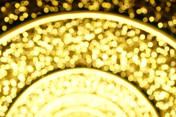 Yellow arching bokeh background with three level of density divided by light bars.