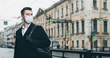 © ANR Production - Quarantine in Europe in 2020. Prevention of coronavirus outbreak. Portrait of young european man wearing a mask in the city street. Prevent pollution and disease concept