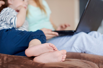 Mother and son using laptop together