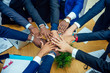 © yurakrasil - top view of team work high five a group of successful afro americans, europeans ,arabic and korean businessman and businesswoman working