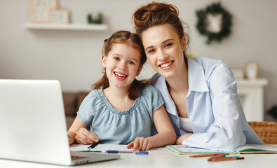 Canvas Print - Happy girl with mother studying online at home.