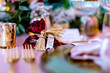 Wedding napkins on a table with red pink and white bouquet and golden fixtures