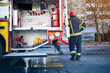 © luckybusiness - Man firefighter standing near fire engine..First Responders – firefighters.