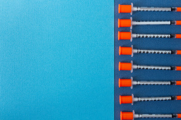 syringe injection needle on blue textured background. medicine template series. empty space for text