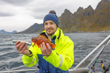 Happy Fisherman With Rockfish (also Called Ocean Perch, Sea Perch Or Redfish) In Hands