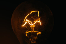 Close-up Of Illuminated Light Bulb In Darkroom