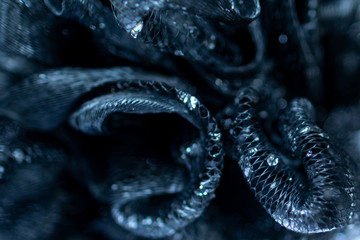 Background and backsplash of wet net with moist crystal water drops stuck between strings - abstract structure, technology, design twists brain macro
