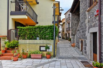 A narrow street between the old houses of a village in the province of Benevento, Italy