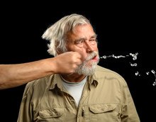 Mature Male Caucasian Adult Getting Punched In The Face On A Solid Black Background