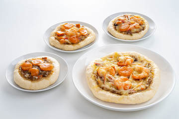 Pizza Cheese with Shrimp, Pork, Imitation Crab Stick and Salted Eggs on White Dish Wood Table.