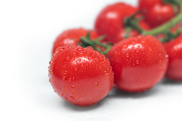 Closeup of fresh red tomato isolated on a white background. Washed tomatoes on the table. Healthy lifestyle. Seasonal and summer vegetables