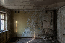 Abandoned Hotel Building. Abandoned Room With Cracked Walls And Peeling Paint. Broken Sink And Stove. Horror Interior