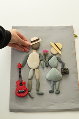 The child is playing with stones from children’s activities.kid making step by step man and woman handcraft picture for nursery or kindergarten activity concept time.