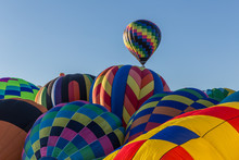 A Pillow Top Of Hot Air Balloons Gets Ready To Go In The Early Morning At The Mass Ascension During The Albuquerque Balloon Fiesta, New Mexico, USA