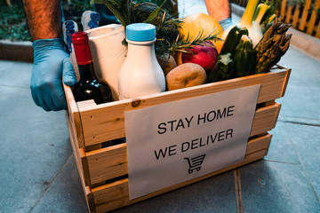 delivery of fresh food ordered online while in home isolation during quarantine for Covid- 19. Stay home we deliver sign on box.