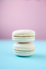 Wall Mural - White macarons on pink and blue background