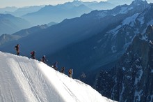 People Hiking On Snowcapped Mountain