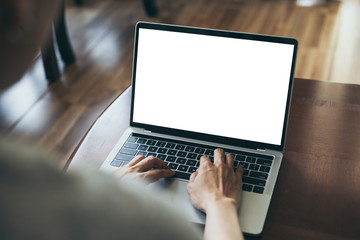 computer mockup image blank screen with white background for advertising text,hand woman using laptop contact business search information on desk at coffee shop.marketing and creative design