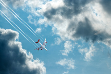 Passenger plane, airliner on a background of blue sky bottom view. The concept of air travel, travel. Copy space.