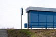 © woff - Stop the suburban bus. Modern steel roadside bus stop with seat. Countryside