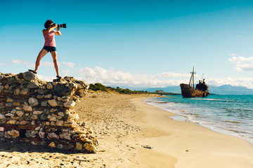 Wall Mural - Tourist take photo on beach sea shore