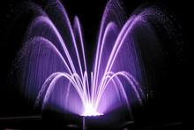 Illuminated Purple Fountain At Night