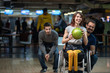 © Marko Rupena - Disabled woman in a wheelchair bowling with friends
