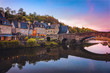 The picturesque medieval port of Dinan on the Rance Estuary, Brittany,France.The medieval city of Dinan in the setting sun, a popular tourist spot in France