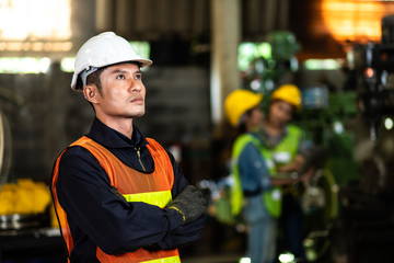 Wall Mural - Man Worker at industrial factory wearing uniform and hardhats. Engineering and architecture concept