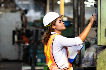 Wall Mural - Manufacturing Factory female Mechanical Engineer Works on Personal Computer at Metal lathe industrial manufacturing factory. Factory Engineer Operating  lathe Machinery