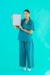 © siraphol - Portrait beautiful young asian doctor woman with empty paper board for copy space