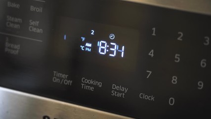 Close up of oven display flickering, control panel blinking. Electricity problem