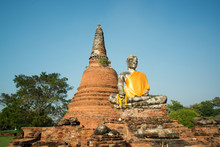 Low Angle View Of Buddha Statue By Temple At Ayutthaya Historical Park