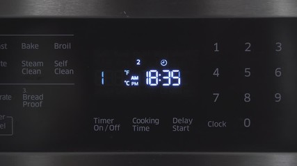 Close up of oven display flickering, control panel blinking. Electricity problem
