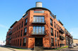 © Olga Save - Modern apartments in the house built of red bricks. House corner with balconies over entrance door.