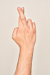 © Krakenimages.com - Hand of caucasian young man showing fingers over isolated white background gesturing fingers crossed, superstition and lucky gesture, lucky and hope expression
