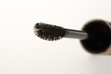 Close-up of a mascara brush with a white background