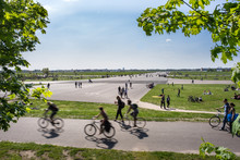 People Riding Bicycle On Road Against Sky