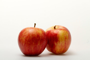 Two apples in red and yellow on a light background