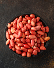 Wall Mural - Peanuts in wooden bowl on rustic background