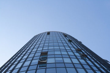 Huge glass business building on blue sky background