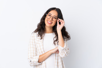 Wall Mural - Mixed race woman over isolated white background with glasses and happy