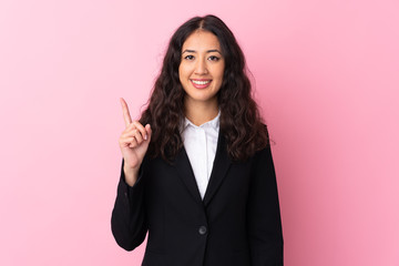 Wall Mural - Mixed race business woman over isolated pink background pointing with the index finger a great idea