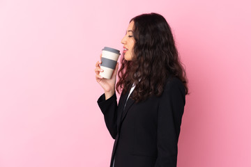 Wall Mural - Mixed race business woman holding coffee to take away over isolated pink background