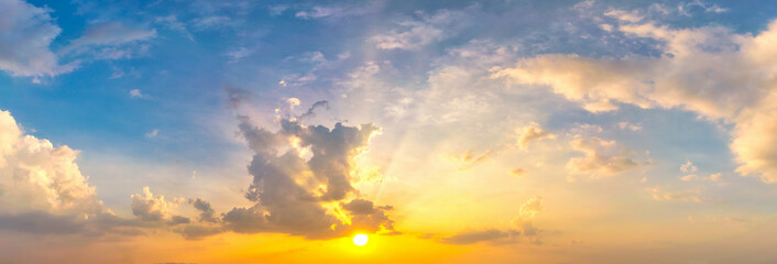 Wall Mural - Sky blue and orange light of the sun through the clouds in the sky