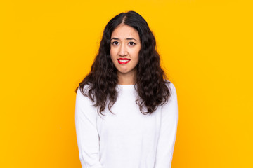 Sticker - Mixed race woman over isolated yellow background having doubts and with confuse face expression