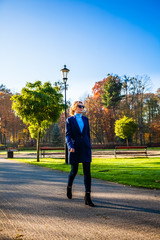 Wall Mural - Middle-aged woman walking in city park