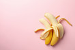 © Atlas - Opened bananas on pink background. Fresh fruit